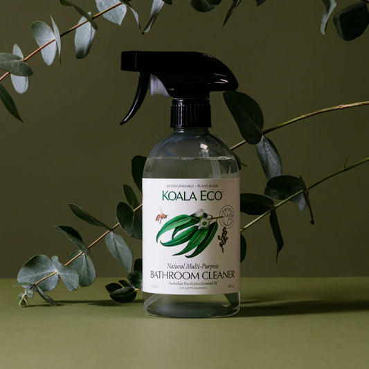 Bottle of Koala Eco Bathroom Cleaner with eucalyptus leaves on a green background
